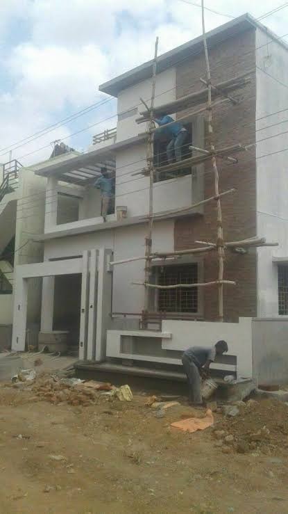 Small house facade under construction with bamboo scaffolding